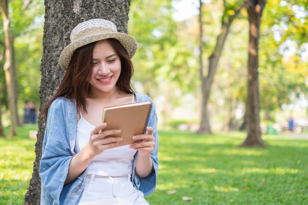 Portrait of beautiful asian woman reading book relaxing