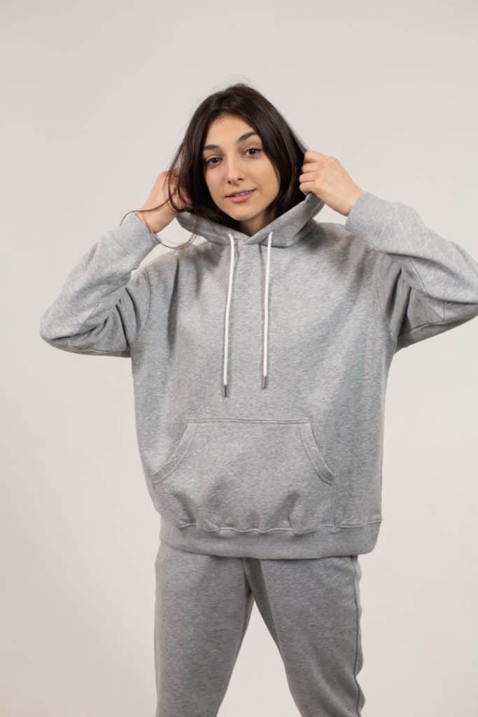 Woman wearing light grey hoodie
