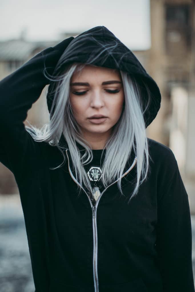 Woman with silver hair wearing dark grey or black hoodie
