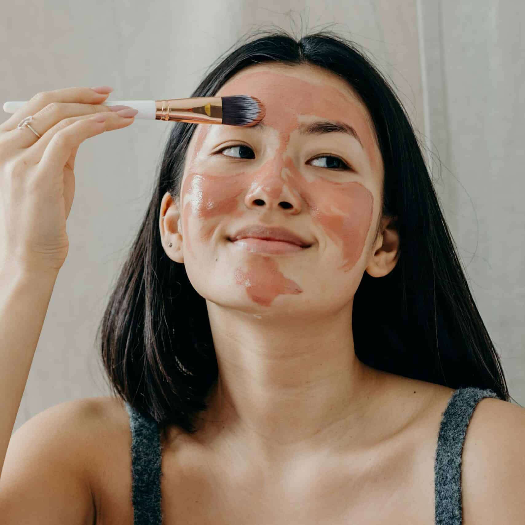 A Woman in Gray Tank Top Doing Her Skin Care clay mask