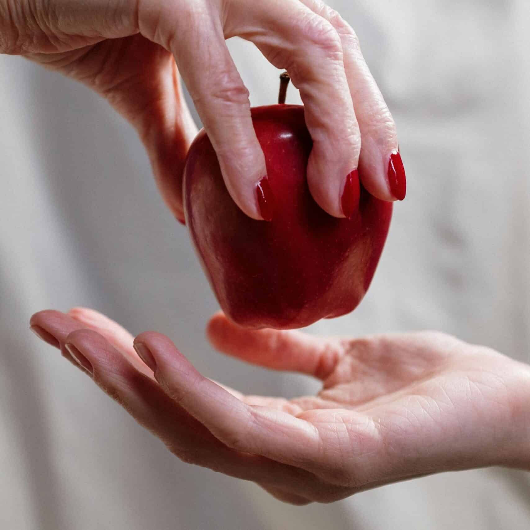 Person Holding Red Heart Shaped Ornament